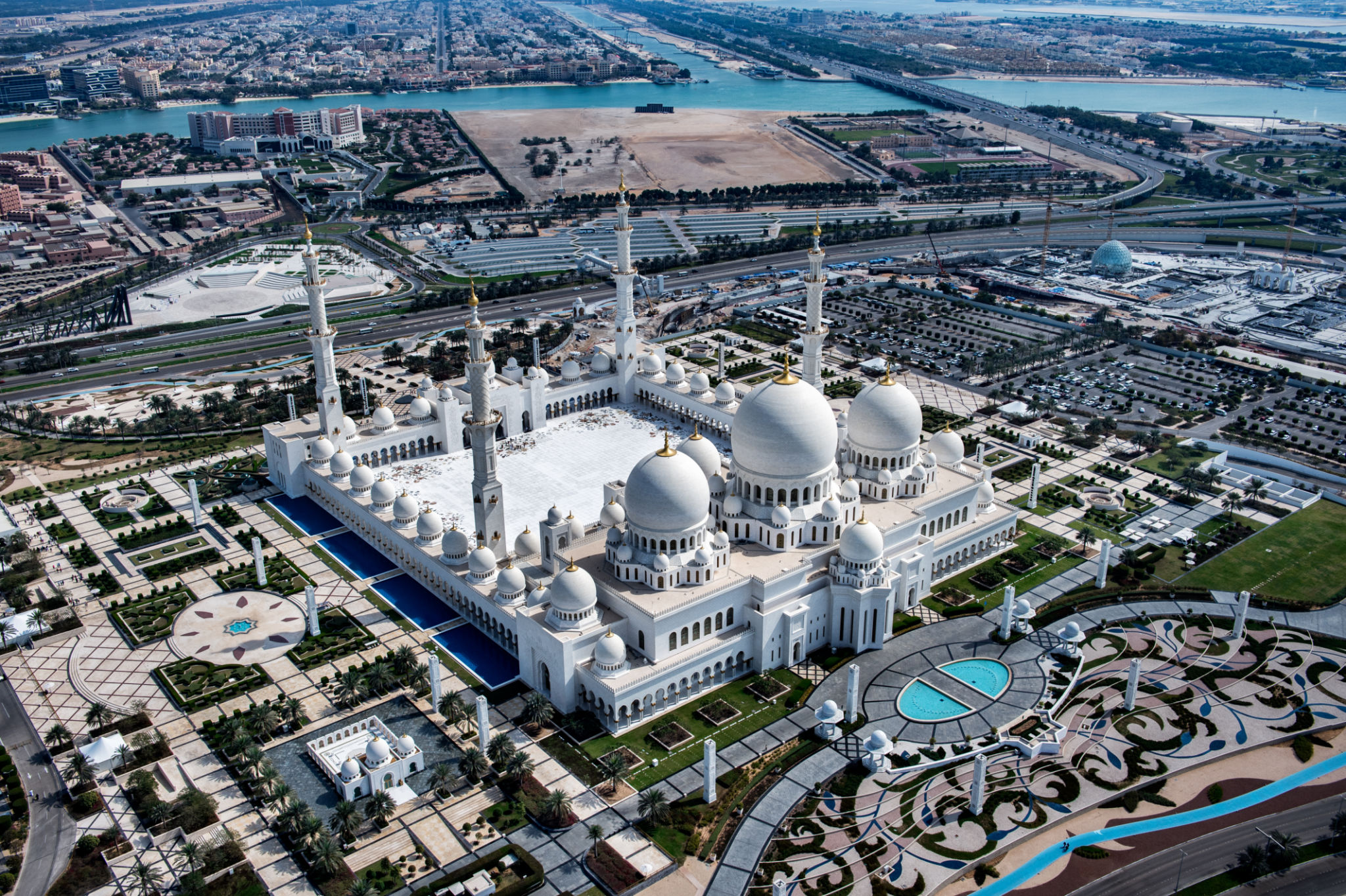 The grand white marble courtyard and minarets of Sheikh Zayed Grand Mosque in Abu Dhabi, UAE